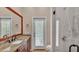 Bathroom features granite counters, dual sinks, and a glass enclosed shower at 1455 Royal Forest Loop, Lakeland, FL 33811