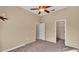 Neutral bedroom features ceiling fan, neutral paint, and carpeted floor at 1455 Royal Forest Loop, Lakeland, FL 33811