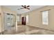 Bedroom with tile floor and sliding glass door with a view of the pool at 1455 Royal Forest Loop, Lakeland, FL 33811
