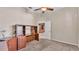 Neutral bedroom features an adjacent study area and carpeted floor at 1455 Royal Forest Loop, Lakeland, FL 33811