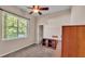 Bedroom features a large window, a ceiling fan, and a closet at 1455 Royal Forest Loop, Lakeland, FL 33811