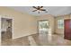Bright bonus room featuring tile floors, a ceiling fan, and sliding glass doors at 1455 Royal Forest Loop, Lakeland, FL 33811