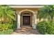 Elegant front entrance with a brick walkway and meticulously maintained landscaping at 1455 Royal Forest Loop, Lakeland, FL 33811