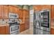 Kitchen with stainless steel appliances and wooden cabinetry, leading to the front door at 1455 Royal Forest Loop, Lakeland, FL 33811