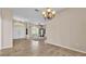 Open-concept living room featuring tile floors and a chandelier at 1455 Royal Forest Loop, Lakeland, FL 33811