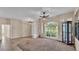 Open living area with tile and carpet flooring, large windows, and modern fixtures at 1455 Royal Forest Loop, Lakeland, FL 33811
