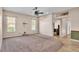 Large living room with neutral carpet, ceiling fan, and abundant natural light at 1455 Royal Forest Loop, Lakeland, FL 33811
