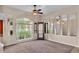 Bright living room with large windows, mirrors, and neutral decor at 1455 Royal Forest Loop, Lakeland, FL 33811