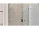 Shower featuring clear glass doors, tiled walls and bronze fixtures at 1455 Royal Forest Loop, Lakeland, FL 33811