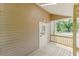 Covered back porch features a white door at 1480 Wauchula St, Intercession City, FL 33848