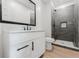 Contemporary bathroom with a black framed mirror, white vanity, and tile surround shower at 1480 Wauchula St, Intercession City, FL 33848