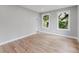 Spacious bedroom featuring wood floors, neutral paint, and ample natural light at 1480 Wauchula St, Intercession City, FL 33848