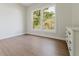 Bright bedroom with a large window and wood floors, complemented by a classic white dresser at 1480 Wauchula St, Intercession City, FL 33848