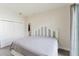 Bright bedroom featuring grey-washed wood floors, neutral walls and a slider door for natural light at 1480 Wauchula St, Intercession City, FL 33848