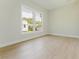 Bedroom with large window, creating a serene and inviting atmosphere and beautiful floors at 1480 Wauchula St, Intercession City, FL 33848