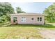 Exterior showcasing a well-maintained yard, back porch, and freshly painted facade with bright windows and a clean design at 1480 Wauchula St, Intercession City, FL 33848