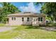 Inviting single-story home with charming curb appeal, lush lawn, and mature shade trees at 1480 Wauchula St, Intercession City, FL 33848