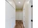 Hallway with beautiful wood flooring, closet space, and easy access to all areas of the home at 1480 Wauchula St, Intercession City, FL 33848
