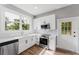 Well-lit kitchen showcases white cabinetry, stainless steel appliances, and modern countertops at 1480 Wauchula St, Intercession City, FL 33848