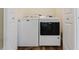 Convenient laundry area featuring a washer and dryer tucked between two white doors at 1480 Wauchula St, Intercession City, FL 33848