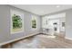 Bright living room featuring wood floors and seamless flow into a modern kitchen with breakfast bar seating at 1480 Wauchula St, Intercession City, FL 33848
