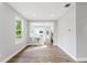 Spacious living room showcases beautiful wood floors and a clear view into a sleek kitchen with bar stools at 1480 Wauchula St, Intercession City, FL 33848