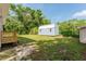 View of the blue shed on the property featuring a white roof and doors at 1480 Wauchula St, Intercession City, FL 33848