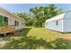 Side view of the house and blue shed in the back yard at 1480 Wauchula St, Intercession City, FL 33848