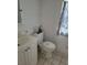 Small bathroom featuring a vanity, toilet and patterned curtain at 1519 Illinois Ave, St Cloud, FL 34769