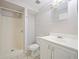Bathroom with a standing shower, white vanity, and neutral-toned tile flooring at 1519 Illinois Ave, St Cloud, FL 34769
