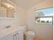 Bright bathroom with white fixtures, a window providing natural light, and tile flooring at 1519 Illinois Ave, St Cloud, FL 34769