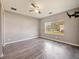 Bedroom with wood-look laminate floors and a large window at 1519 Illinois Ave, St Cloud, FL 34769