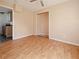 Bedroom with hardwood floors, open closet, and simple ceiling fan at 1519 Illinois Ave, St Cloud, FL 34769