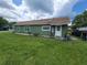 Green home exterior with a well maintained lawn and blue bicycle parked near the entrance at 1519 Illinois Ave, St Cloud, FL 34769