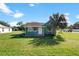 Quaint green house with a cozy front porch, complemented by a mature palm tree at 1519 Illinois Ave, St Cloud, FL 34769