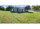 A green, single-story home with a spacious yard at 1519 Illinois Ave, St Cloud, FL 34769