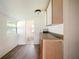 Compact kitchen area with simple cabinetry and view into a bathroom at 1519 Illinois Ave, St Cloud, FL 34769