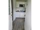 Small kitchenette with white cabinets and basic appliances at 1519 Illinois Ave, St Cloud, FL 34769