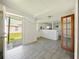 Open living space with door to exterior and view to kitchen at 1519 Illinois Ave, St Cloud, FL 34769