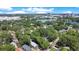 Aerial view displays the property near a lake and city, surrounded by mature trees at 1600 Dauphin Ln, Orlando, FL 32803
