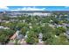 Aerial view showcases the property surrounded by lush greenery in a residential area at 1600 Dauphin Ln, Orlando, FL 32803