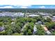 Property aerial view reveals the property near city and lake, embraced by mature trees at 1600 Dauphin Ln, Orlando, FL 32803