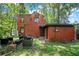 Exterior of house surrounded by lush greenery and a backyard for entertainment at 1600 Dauphin Ln, Orlando, FL 32803