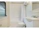 Clean bathroom with white tub, white tile, and modern toilet and sink at 1600 Dauphin Ln, Orlando, FL 32803