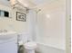 Bright bathroom featuring a shower-tub combination with white tile, a vanity, and toilet at 1600 Dauphin Ln, Orlando, FL 32803