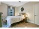 Bedroom featuring a bed with a wooden headboard, wood floors, and chevron curtains at 1600 Dauphin Ln, Orlando, FL 32803
