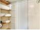 Walk-in closet with wooden shelving containing neatly folded towels and linens at 1600 Dauphin Ln, Orlando, FL 32803