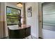 Cozy dining area with modern table set, flower vase and a sunlit window overlooking trees at 1600 Dauphin Ln, Orlando, FL 32803