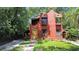 Charming red home with a yellow front door, balconies, and well-kept front yard at 1600 Dauphin Ln, Orlando, FL 32803