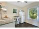 Sunlit kitchen features dark wood floors, white cabinets, and modern appliances at 1600 Dauphin Ln, Orlando, FL 32803